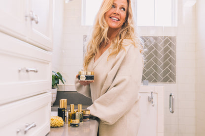 Beautiful woman with the Generation Bee body cream in front of the mirror
