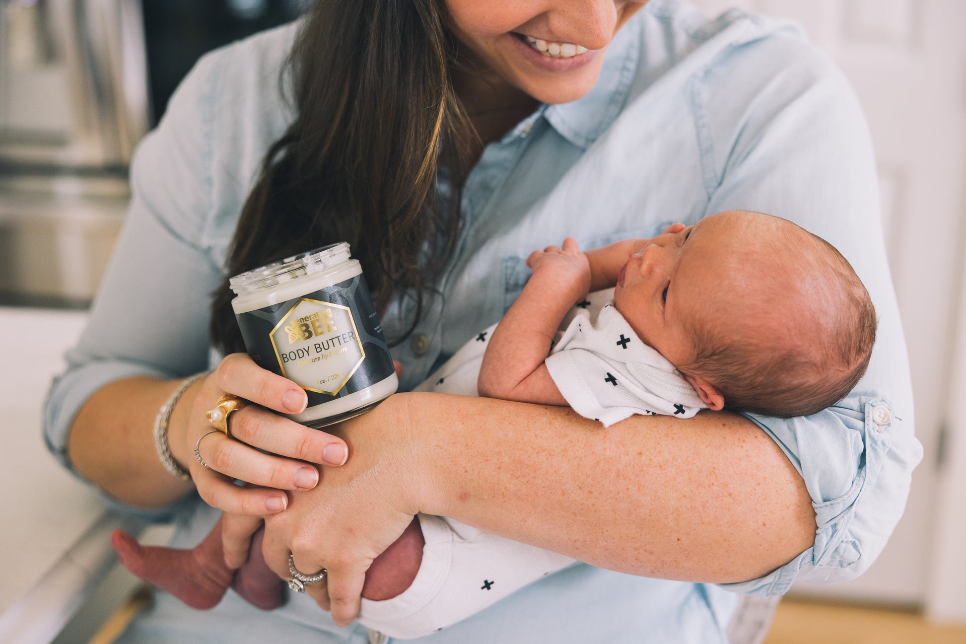 Mother with Gen Bee body butter and a baby