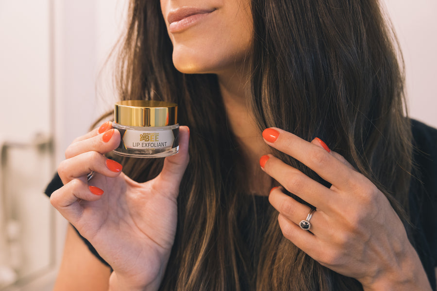 Woman with Generation Bee Lip Exfoliant jar in her hand